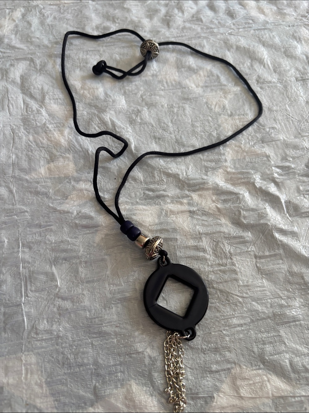 Black Cord Necklace with Geometric Pendant and Silver Tassel Accent
